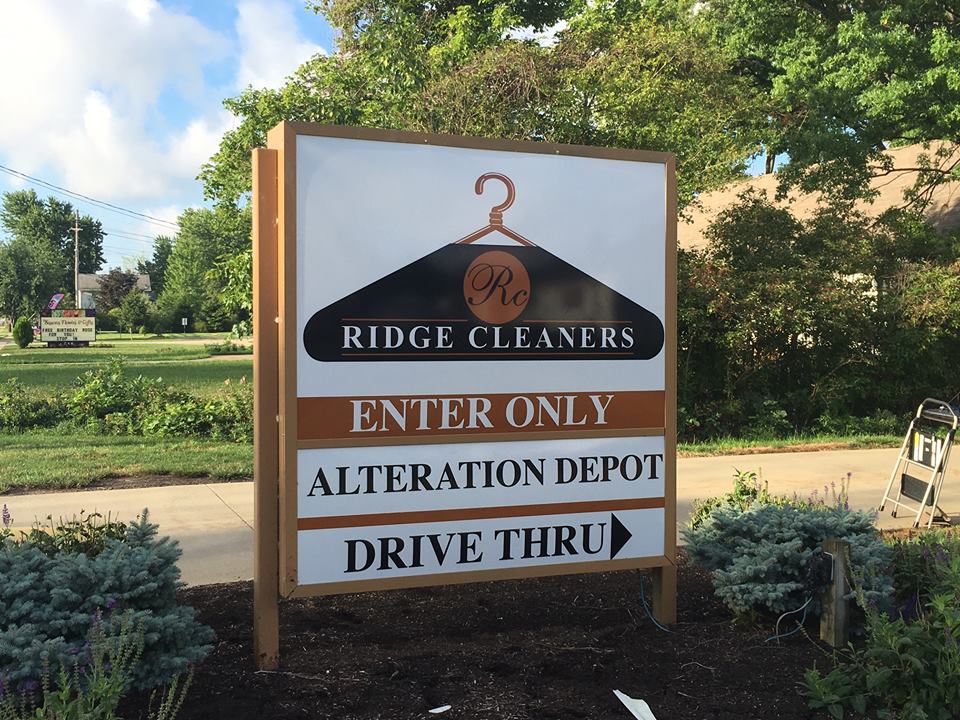 Directional signage on road for Ridge Cleaners