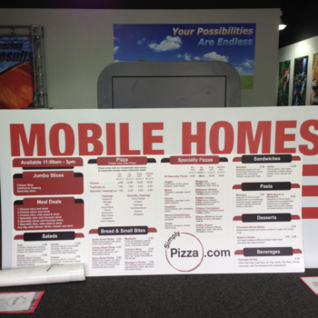 Show room with large posters for Mobile Homes and Simply Pizza's menu 