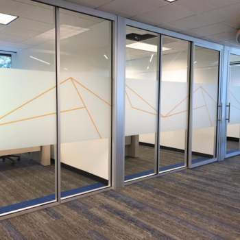 Indoor window decals in an office building featuring line pyramid design
