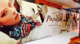 Wall mural inside of a mall advertising the grand opening of Papaya store featuring close up images of models 