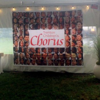 Banner featuring many faces of the Trenton Children's Chorus