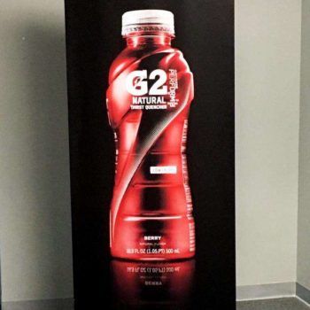 Red G2 Gatorade bottle that is flavored with berry and is pictured on a banner with a black background.