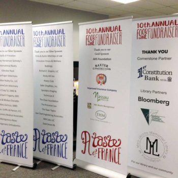 4 banner signs advertising an event called A Taste of France, which will be the 10th year of the event