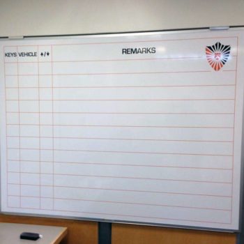 Whiteboard with graph for a company to keep track of vehicles, keys, and remarks.