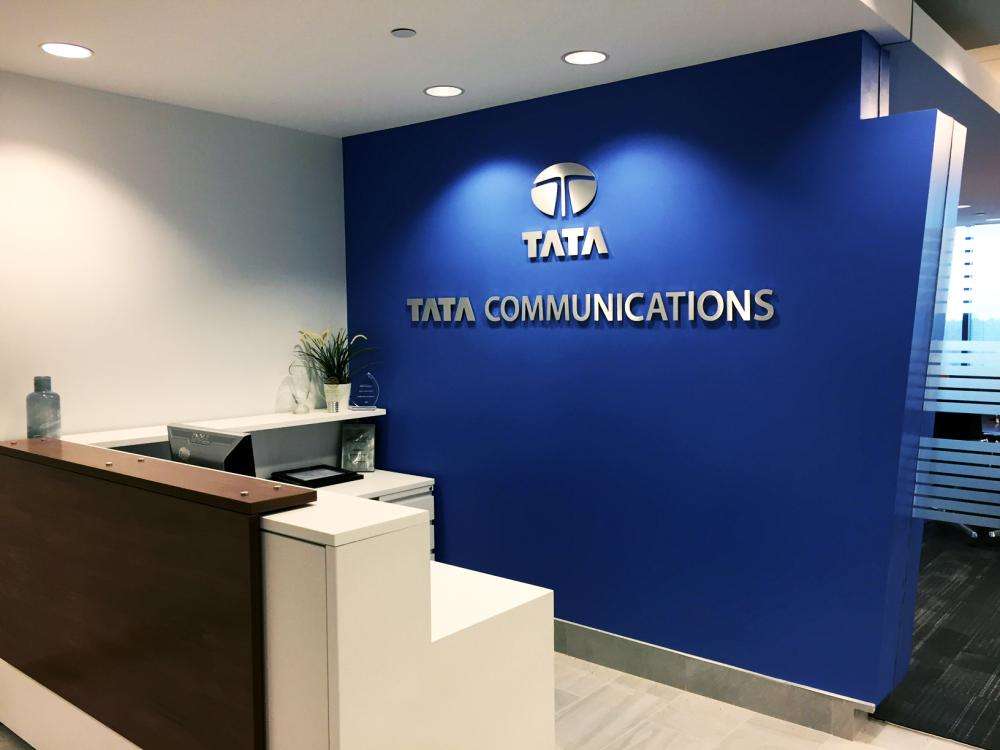 Tata Communications logo on a blue wall