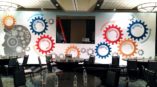 Meeting room wall graph with many gears that all relate to the brain. The gears are synergy, collaboration, value creation, quality, performance, innovation and integrity.