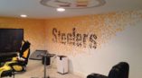 Wall mural with Steelers in black font and yellow dots everywhere around it.