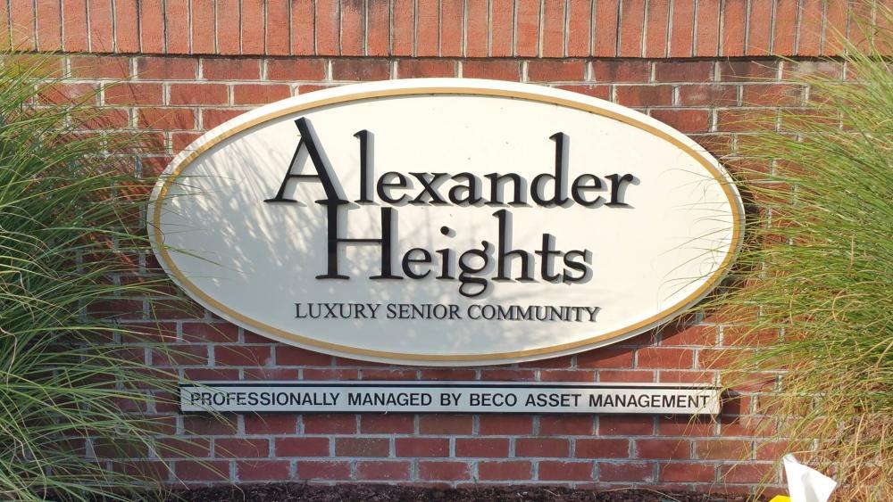 A road sign on bricks for Alexander Heights, a luxury senior community
