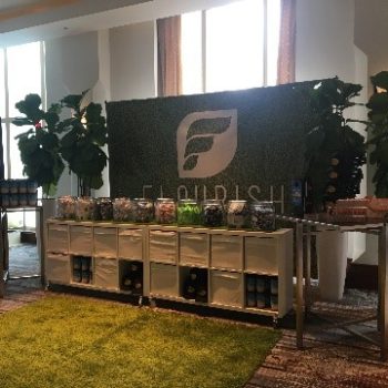 An earthy tradeshow display with trees and grass