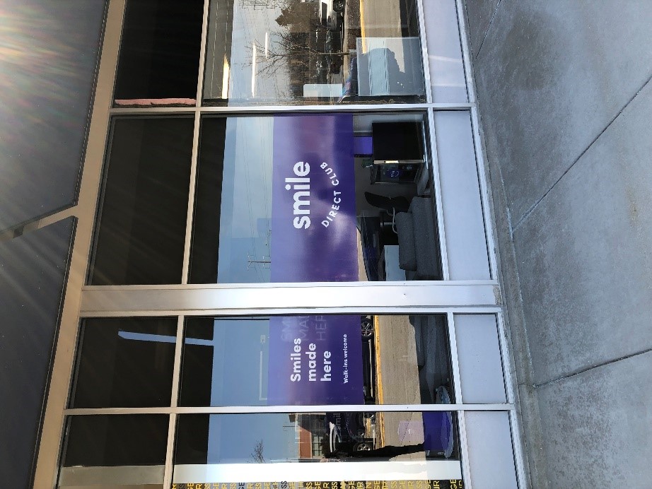 Purple and white window graphics for Smile Direct Club