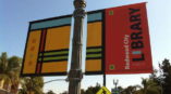 Banners hanging from a light post for the Redwood City Library in Chicago. 