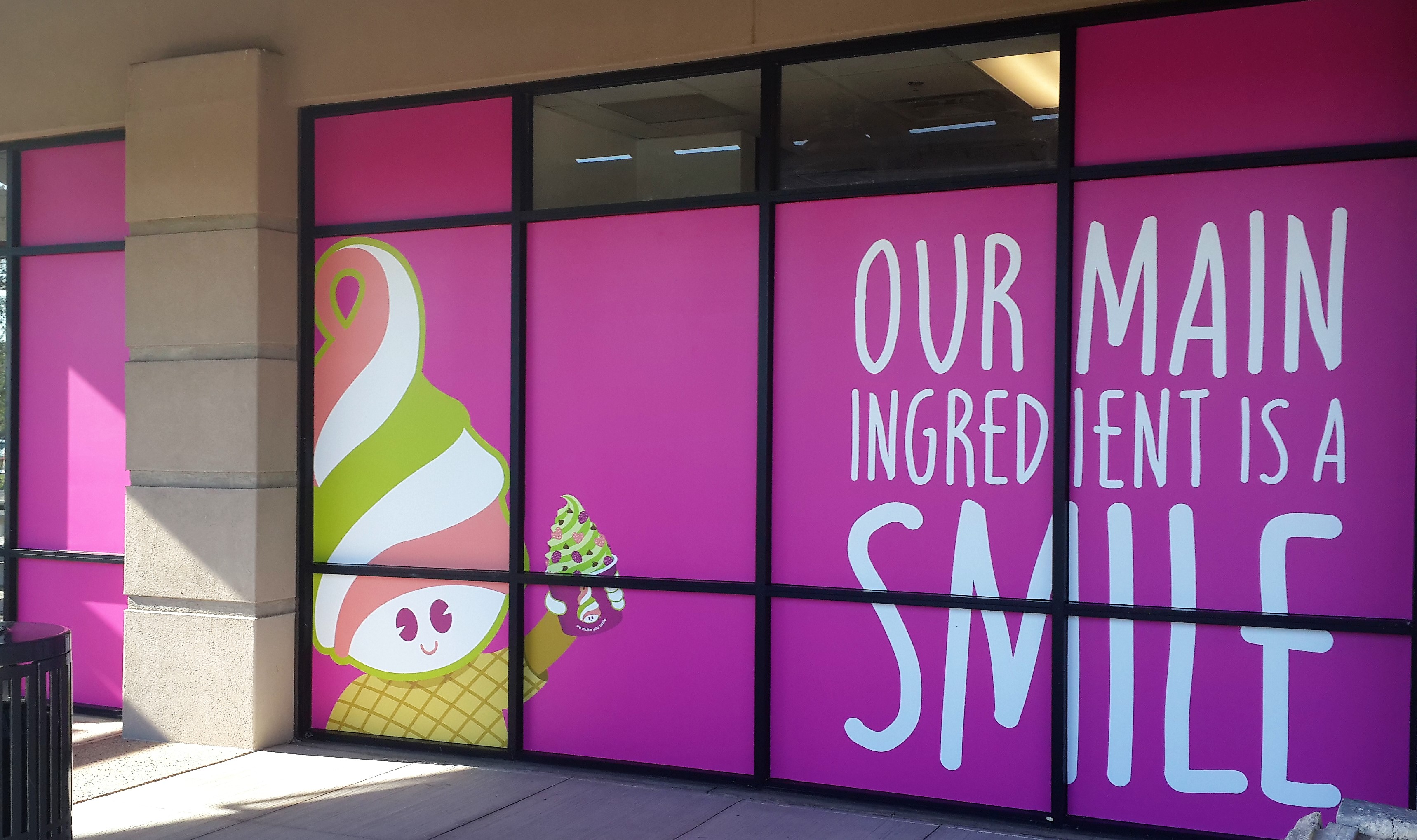 Window signage with phrase our main ingredient is a smile