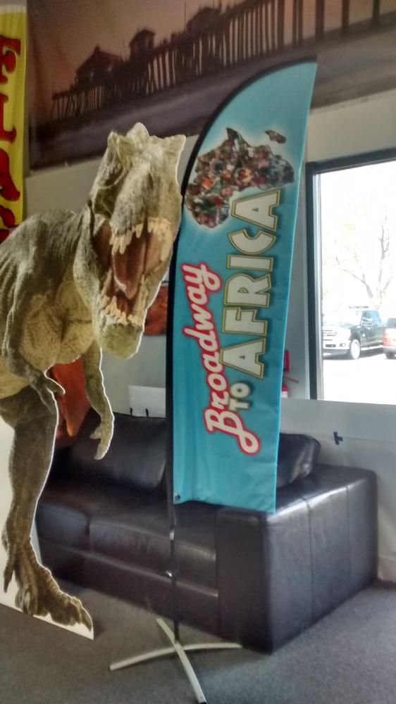 Broadway to Africa flag next to T-rex cut out