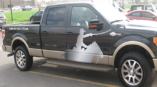 Truck decal of the outline of a cowboy on a horse with a sword