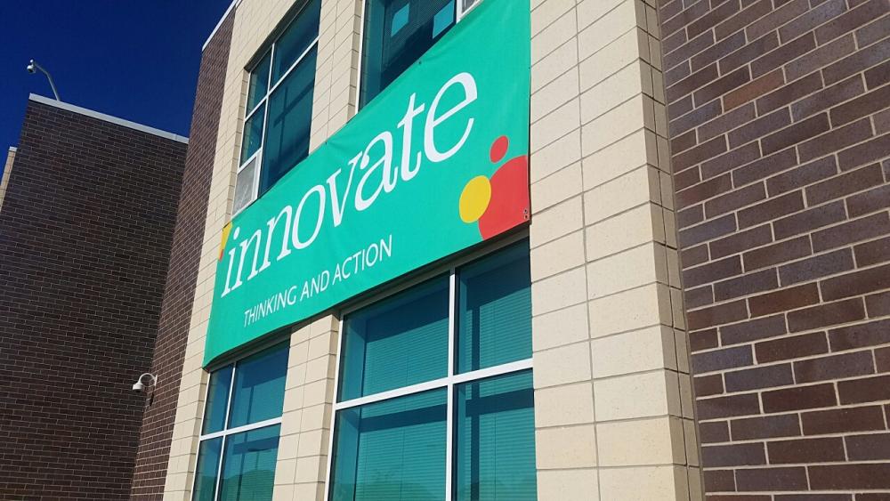 Innovate outdoor hanging vinyl sign