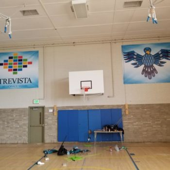 Trevista and graphic bird vinyl banners hanging in basketball court