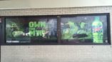 Mountain Dew window graphic advertisement with snowboarder and skier