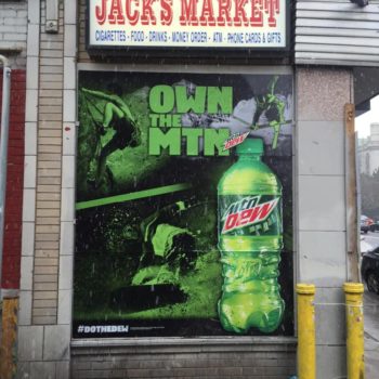 Mountain Dew window graphic with snowboarder and skier at local market