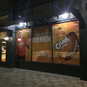 Crush soda window graphic advertisement with Derek Wolfe