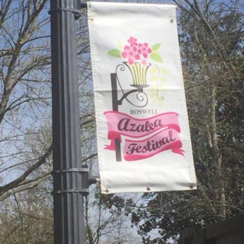 Curbside banner on lamp post for the Roswell Azalea festival featuring images of flowers and vines 