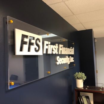 Acrylic and cut vinyl sign mounted offset behind reception desk