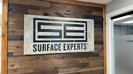 Surface Experts interior sign installed on wood wall
