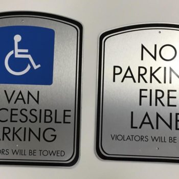 Wall signs for handicap accessible parking and no parking fire lane. 
