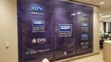 Image of acrylic signs with custom wallpaper, installed in a lobby at Coldwell Banker in Raleigh, NC.