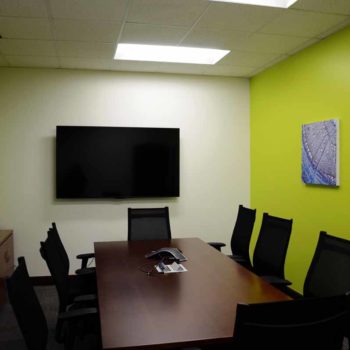 Canvas prints made by SpeedPro Raleigh hanging on the walls of a businesses conference room.in Durham, NC