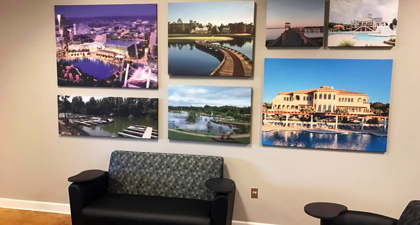 Image of an array of giclee canvas prints, installed in.a lobby in Raleigh, NC.