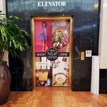 Image of an elevator door cling, installed in a mall in Raleigh, NC.