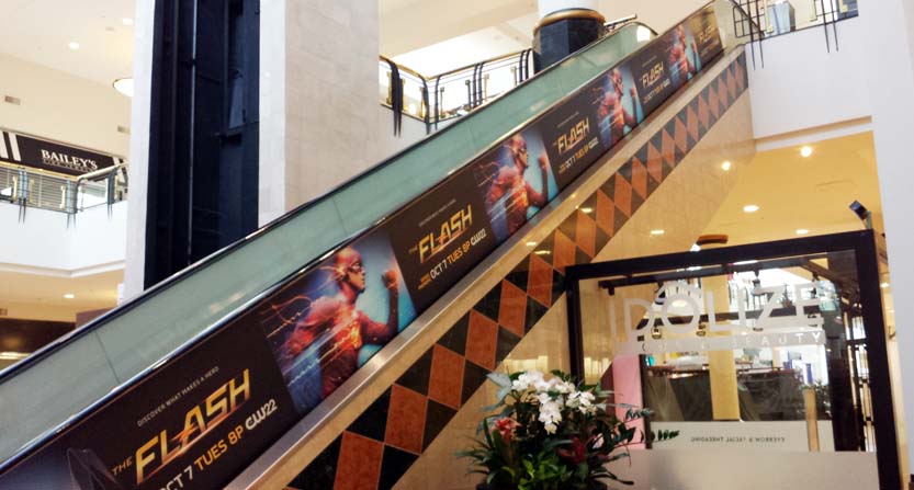 Image of an escalator handrail wrap, installed in a mall in Raleigh, NC.