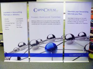 Image of retractable banner stands arranged as a quickwall for an event.
