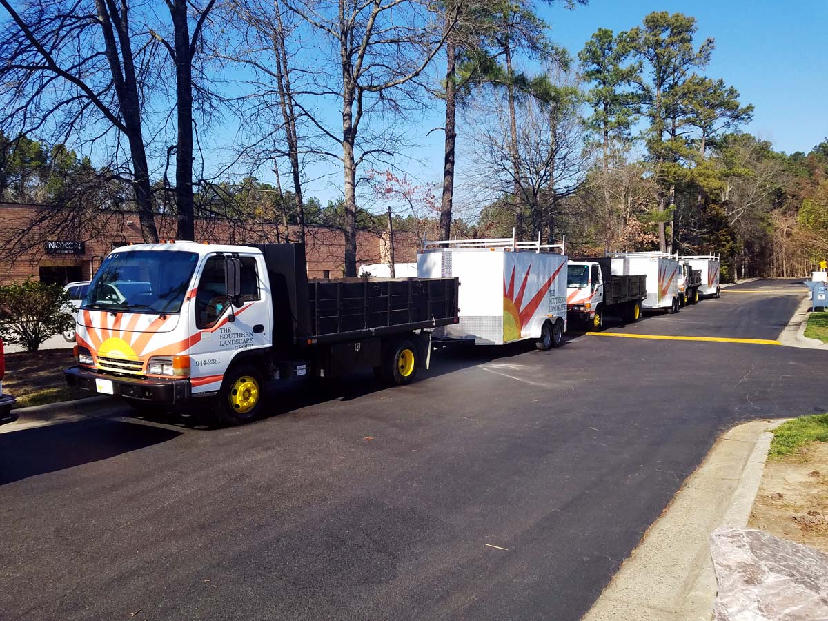 Image of cut vinyl vehicle graphics, installed on an entire fleet of dump truck cabs and trailers in Sanford, NC.