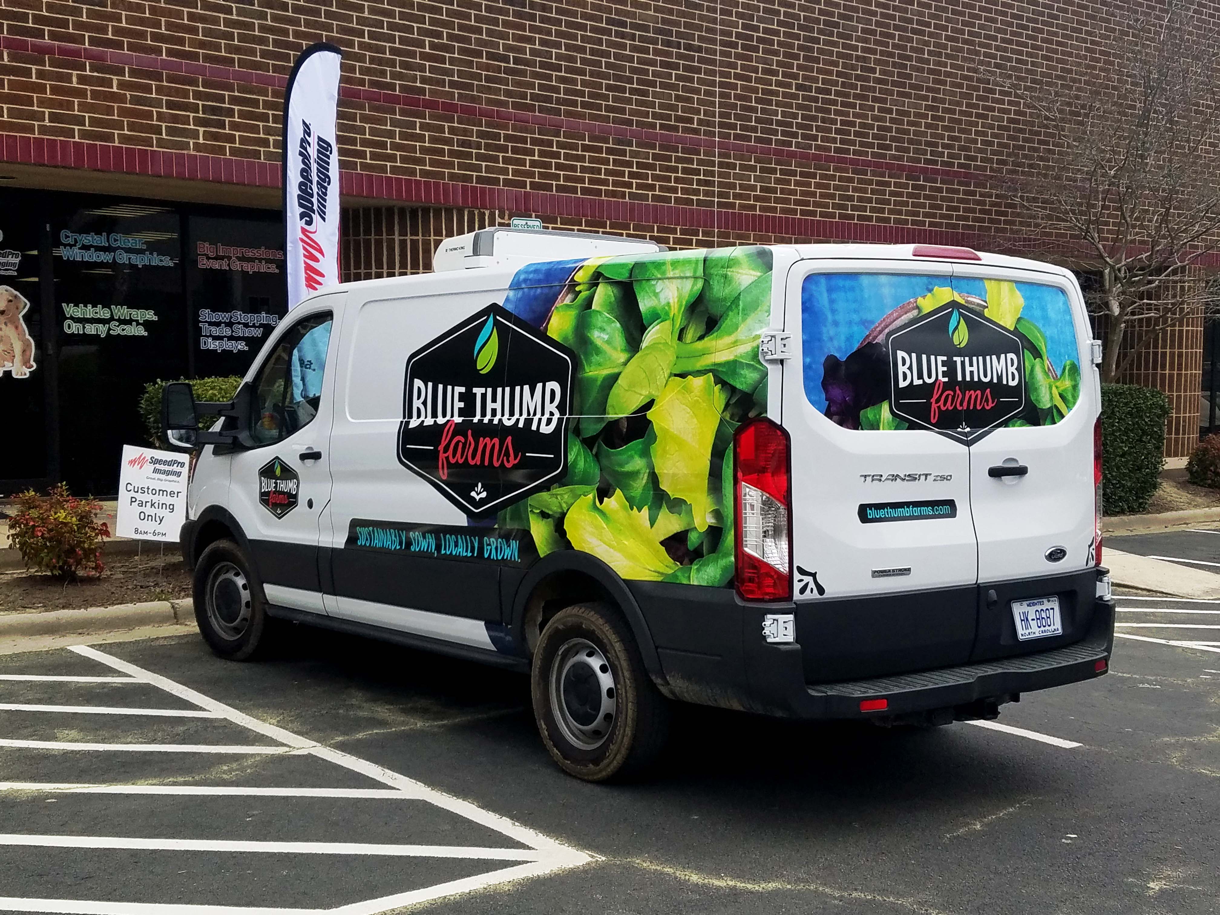 A Ford Transit van with a custom designed vehicle wrap for Blue Thumb Farms in Zebulon, NC