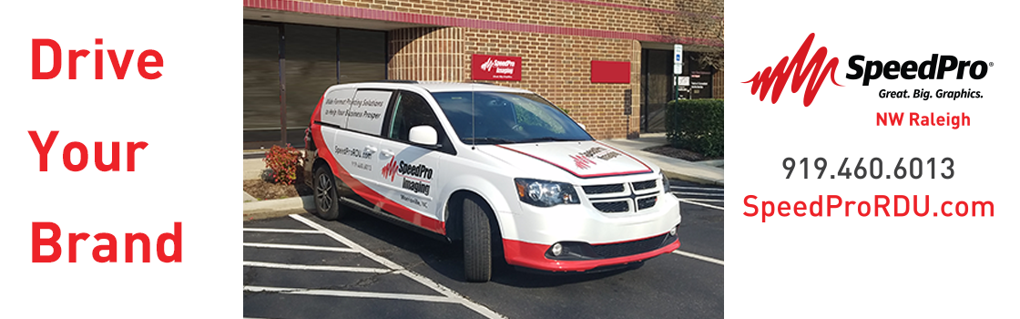 A minivan with a custom vehicle wrap for SpeedPro Raleigh with the text "Drive Your Brand".