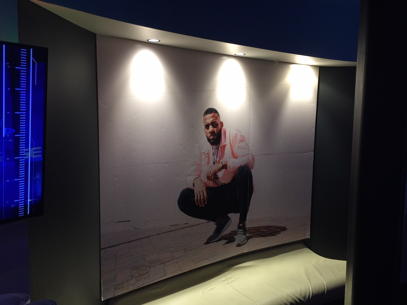 New Balance indoor screen signage of a model
