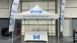 Matching company canopy tent, flags and table cover. Outdoor event setup. Stillwater, Oklahoma.