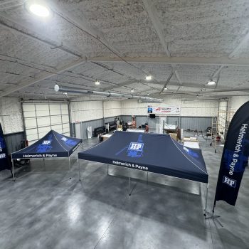 Matching company canopy tent, flags and table cover. Outdoor event setup. Stillwater, Oklahoma.