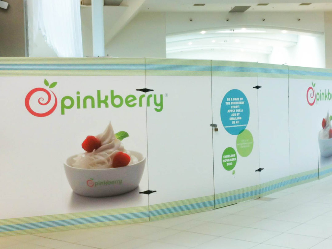 Pinkberry advertisement on construction wall
