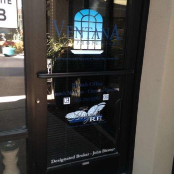 Window decal on glass door with company logo, address and phone number