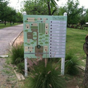 An outdoor directional sign with a map of 
