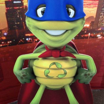 Cutout sign of a turtle superhero promoting recycling