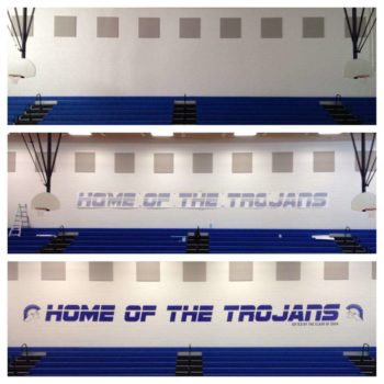 Installing a Gymnasium wall sign over bleachers that says 
