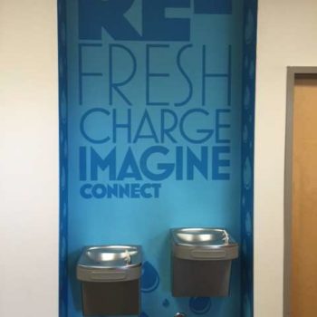 Wall mural graphic behind the water fountains to promote drinking water