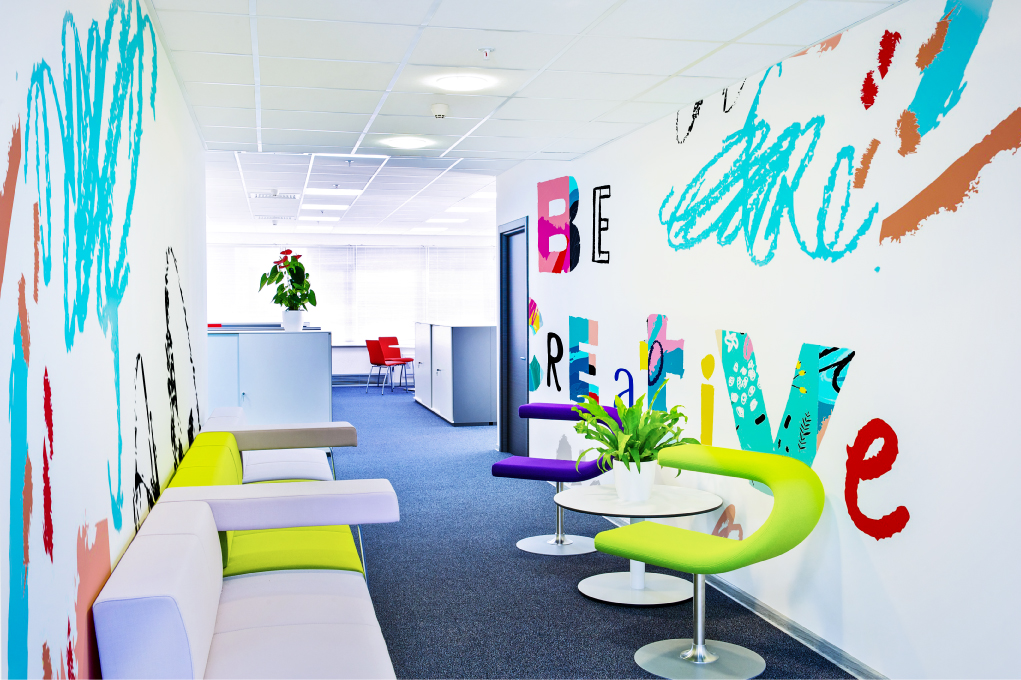 Stylish interior design with colorful chairs and tables under a modern ceiling