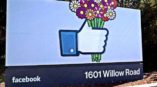Facebook outdoor signage with like button holding flowers