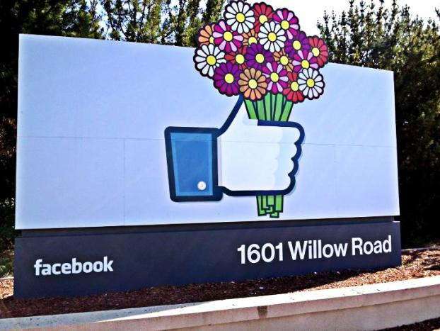 Facebook outdoor signage with like button holding flowers