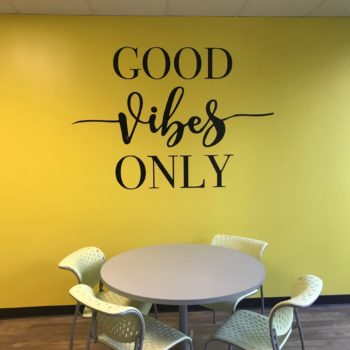 Wall decal on yellow wall with phrase Good Vibes Only