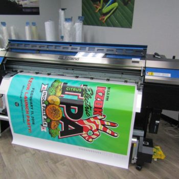 KZOK banner coming off the printer